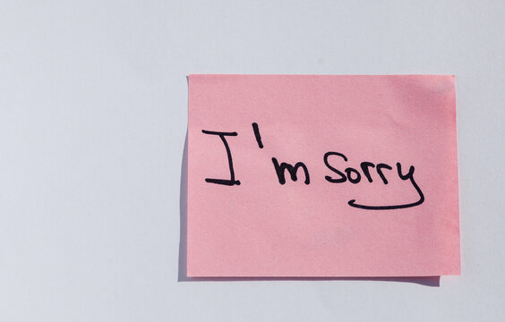 Pink sticky note with handwritten 'I'm Sorry' message