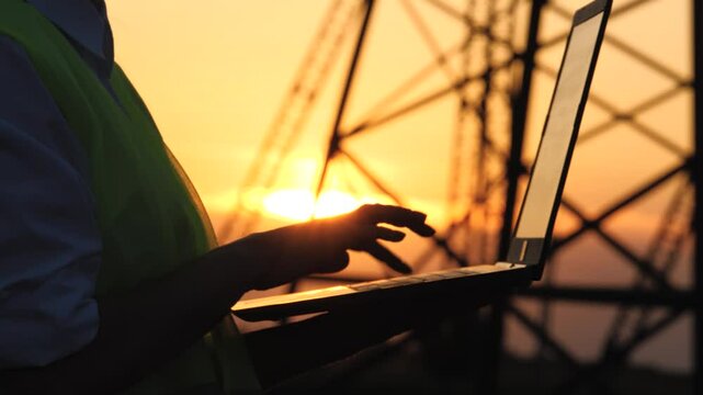 silhouette electrical engineer, work computer tablet sunset, electric tower, digital hand, industry concept near tower, construction, industrial factory, electrician working digital tablet, engineer