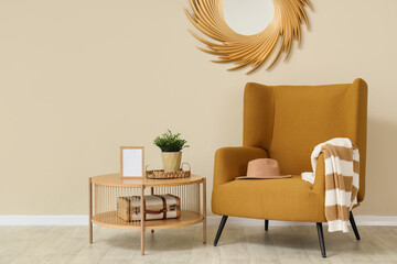 Minimalist interior of living room with brown armchair, coffee table and mirror