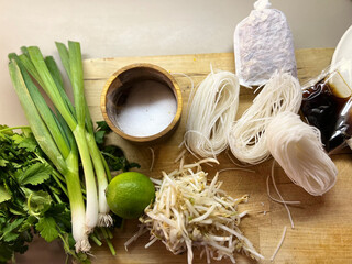 pho soup ingredients on a wooden cutting board