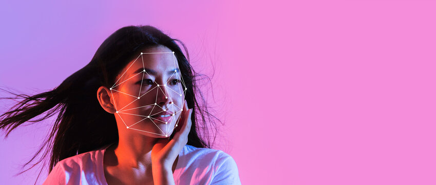 A woman models facial recognition technology with a highlighted facial mapping design. The background features vibrant colors, creating a modern atmosphere that emphasizes technology use.