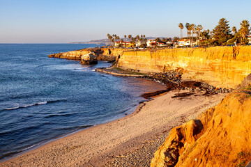 Peaceful Cove at Sunset Cliffs, San Diego, CA during golden hour on a calm day with blue sky.  © Tove Farbrot