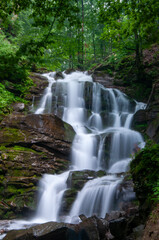 Fototapeta premium A stunning long exposure photograph of Shypit Waterfall in the Carpathian Mountains of Ukraine. The long exposure technique creates a smooth, silky effect on the cascading water