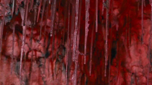 Stalactic in cave with red lights