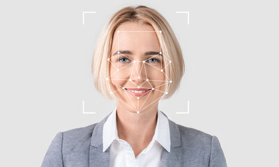 A woman with blonde hair smiles confidently while facial recognition technology analyzes her...