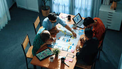 Top view of professional business team brainstorming and sharing idea by using mind map. Diverse people planning marketing strategy or designing Ux Ui design for mobile phone at meeting. Convocation.