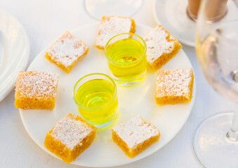 Piece of traditional Spanish almond cake Tarta de Santiago on a white plate
