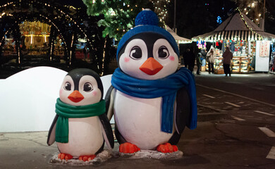 New Year's toy penguins stand next to each other
