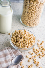 Sweet honey cereal rings in bowl on klitchen table.