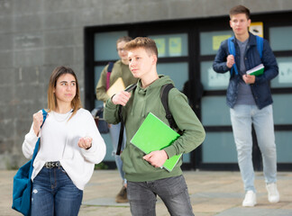 Guy and girl are walking carelessly down the street