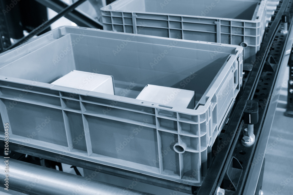 Aufkleber two gray plastic containers on a conveyor belt. the containers are empty and are waiting to be fille