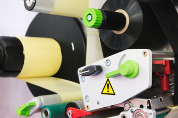 Fragment of the conveyor of sticking labeling machine. Abstract industrial background.