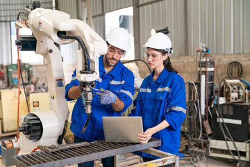 Engineers collaborate on robotic technology in an industrial workshop focused on smart automation