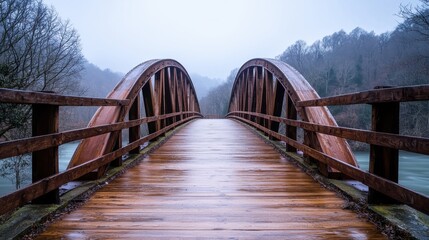 A serene wooden bridge spans a misty landscape, surrounded by trees and water, evoking tranquility and connection to nature.