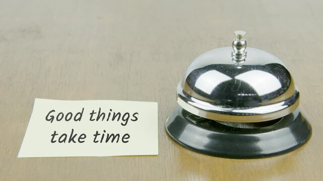 Finger Index Ringing Bell with Good Things Take Time Text or Word on Yellow Note Paper on Desk or Table