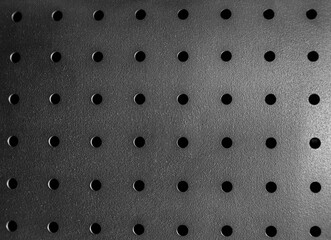 abstract macro metal industrial background with holes silver black texture grid perforated manfucaturing industrial arts pattern