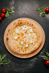 Delicious gourmet pizza with melted cheese and mozzarella balls, baked to golden perfection