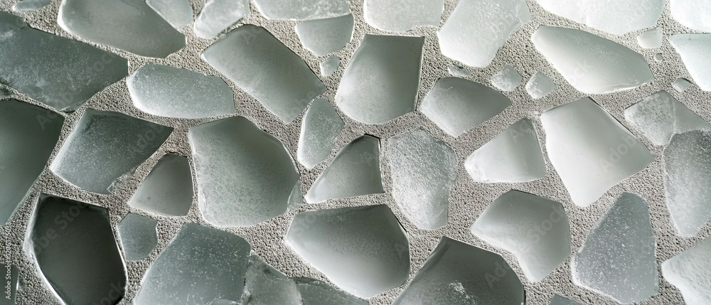 Poster exploring the unique properties of sandblasted glass with rough textures and smooth contours