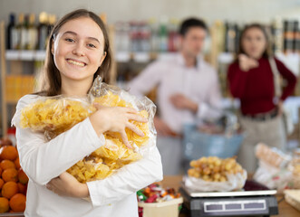 Mom and dad yell at daughter for choosing unhealthy food in store. Girl child has collected many...