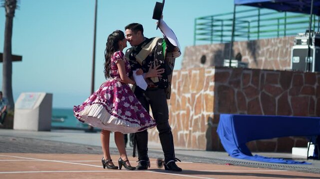 Chilean Huaso dancers performing cueca, traditional chilean dance, during outdoor celebration