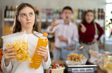 Parents yell at child for buying unhealthy food. Schoolgirl daughter chose sweet drink and potato...