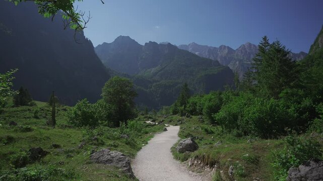 Germany, Salet, Schoenau am Koenigsee. Tourists follow hiking trail from Saletalm to Obersee mountain lake in summer in. Popular hiking route between two lakes in Berchtesgadener Alpen. 