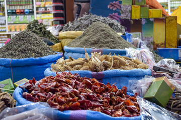Different spices in blue sacks displayed in a local bazaar market in Marrakesh