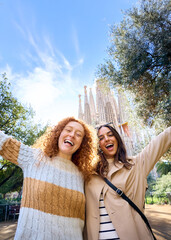 Vertical portrait memories of young caucasian tourist women friends take photo at Sagrada Familia,...
