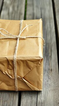 Wrapped parcel resting on wooden surface waiting to be opened during a cozy afternoon