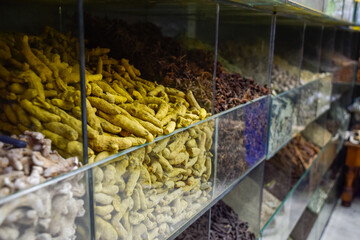 Curry in root and various spices displayed in a local bazaar market in Marrakesh