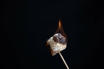 flames from burning marshmallow isolated on black