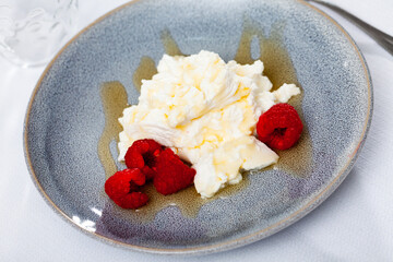 Traditional Catalan dessert - fresh cheese Mato with honey and strawberry