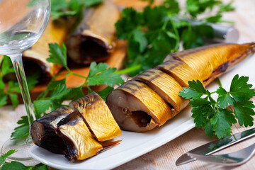 Pieces of delicious smoked scomber with fresh parsley. Fish appetizer..