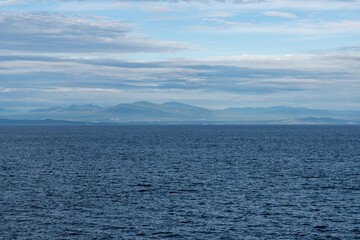 Obraz premium clouds over Strait of Georgia blue sky water landscape mountains on the horizon British Columbia Canada