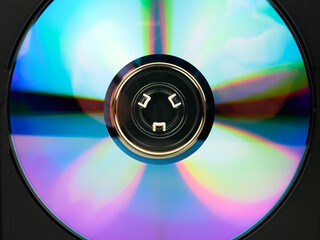 A DVD in a box, close-up. A digital storage medium. Multicolored spectrum of the disk surface