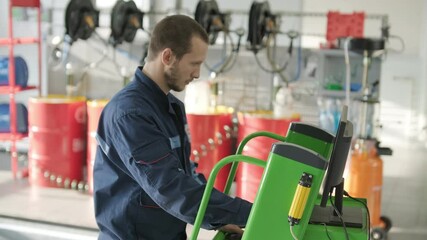 Auto Mechanics Performing Vehicle Diagnostics on Computer