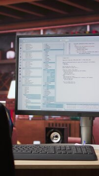 Vertical video UI on PC screen in home office with programming code being executed. Coding application UI used by IT programmers to write and test code in modern apartment, panning shot