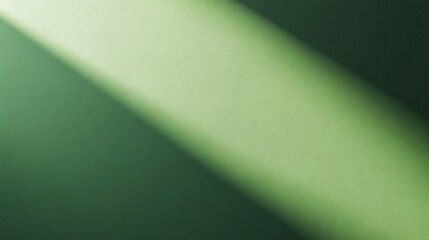 Light beam creating shadow on green wall background texture