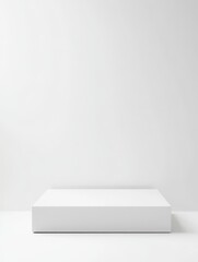 Minimalist white platform against a white wall.