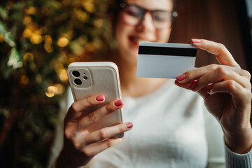 Young caucasian woman buying online on smart phone using credit card	