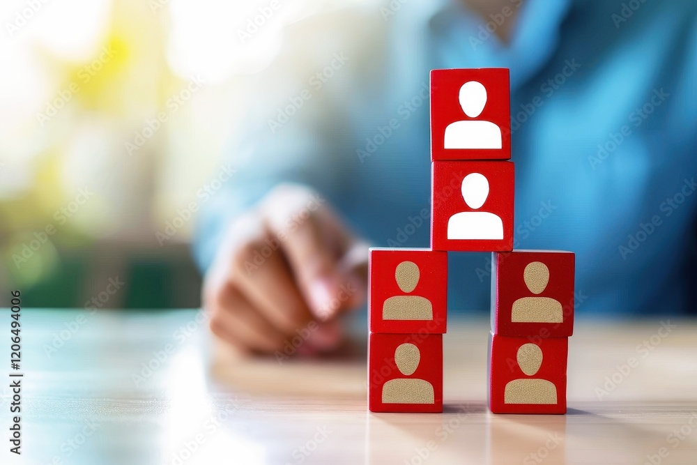 Aufkleber building a strong team: a hand points towards a stack of red blocks with human icons, symbolizing th