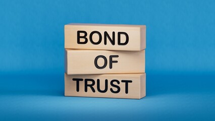 Bond of trust symbol. Wooden blocks with words Bond of trust.Business and Bond of trust concept.Copy space.3D rendering on blue background.