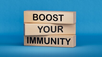 Boost your immunity symbol. Concept word Boost your immunity on wooden blocks.Helthcare and Boost your immunity concept.Copy space.3D rendering on blue background.