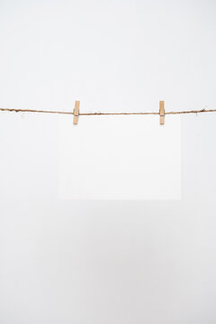 Blank note paper hanging with wooden clips.