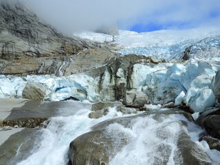 the sermeq glacier and waterfalls at the end of the tasermuit fjord on a sunny summer day near nanortalik, in southern greenland © Nina