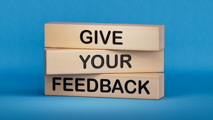 Feedback symbol. Concept word Give your feedback on wooden blocks.Business and Ask for feedback concept. Copy space.3D rendering on blue background.