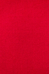 Red cashmere sweater texture pattern. Vertical cozy background. Selective focus, copy space