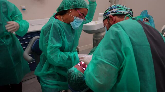 Team of dentists preparing medical equipment to operate a patient