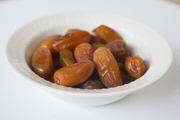close up of fresh date fruit in a bowl on table 