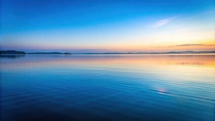 Serene Sunset over a Calm Lake with Gentle Waves Reflecting the Sky